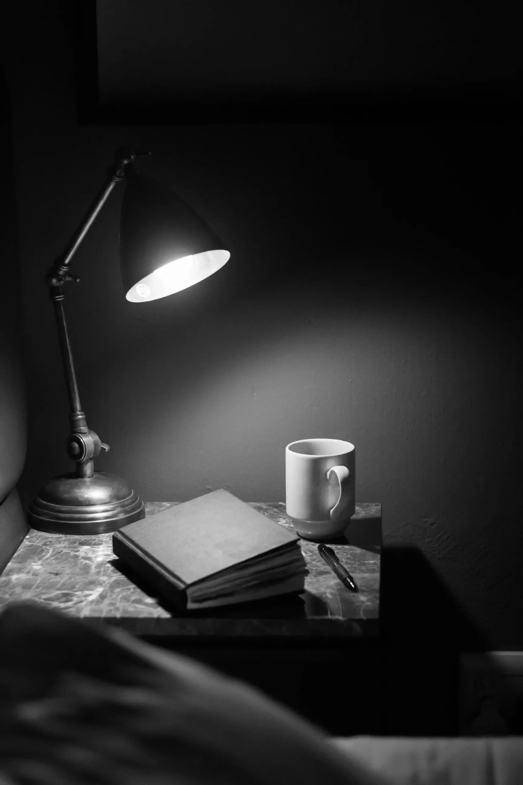 Journaling with lamp and tea. In black white. Journaling before going to bed.